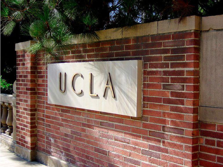 Photo of UCLA entrance sign made of brick and spelling out UCLA in gold letters