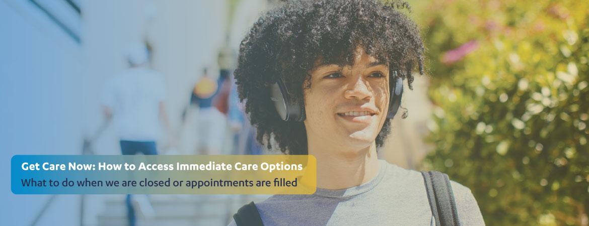 Close up of student with bucket headphones and curly hair, grinning