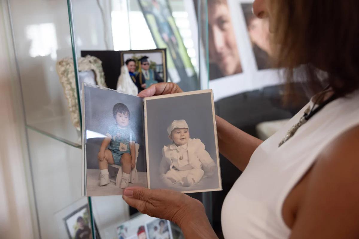 Bobby's mother looking over childhood photos of Bobby