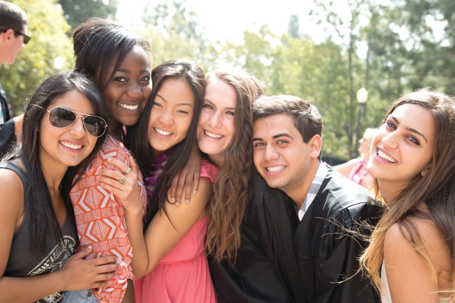 A group of students smiling together outside
