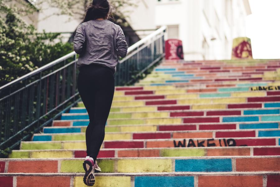 Student jogging up a set of stairs