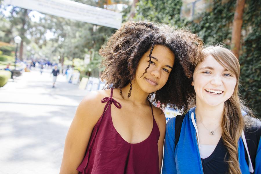 Two students walking outside together